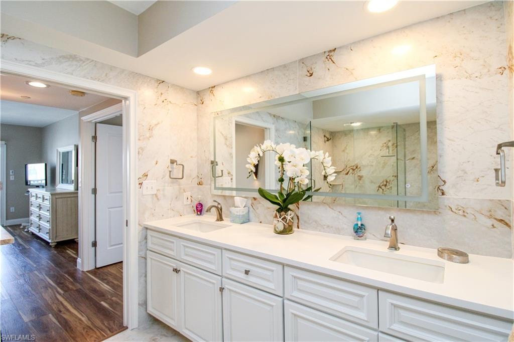 Bathroom featuring vanity, an enclosed shower, and hardwood / wood-style floors