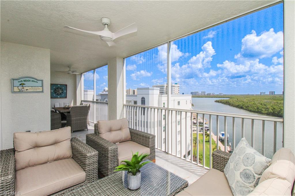 Sunroom featuring a water view and ceiling fan