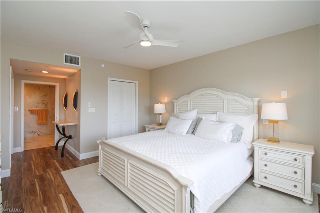 Bedroom with a closet, ceiling fan, and dark wood-type flooring