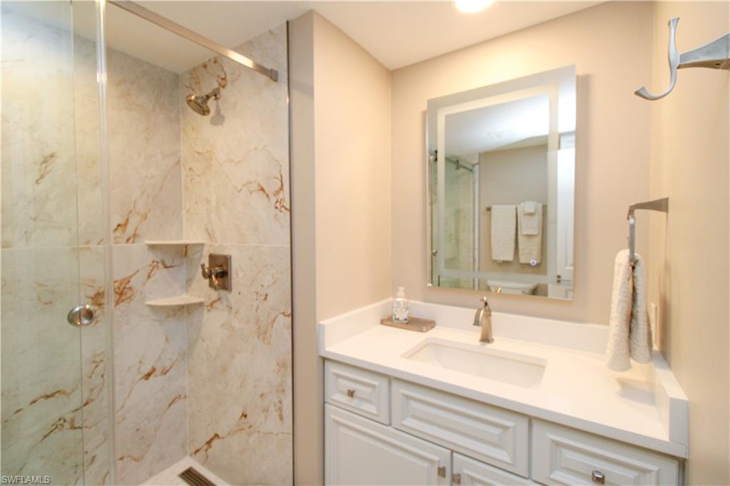 Bathroom featuring vanity and a tile shower