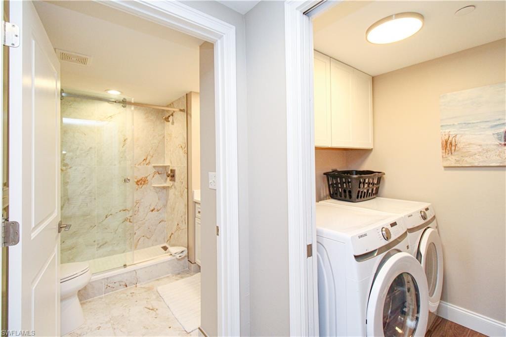 Laundry room with washer and clothes dryer