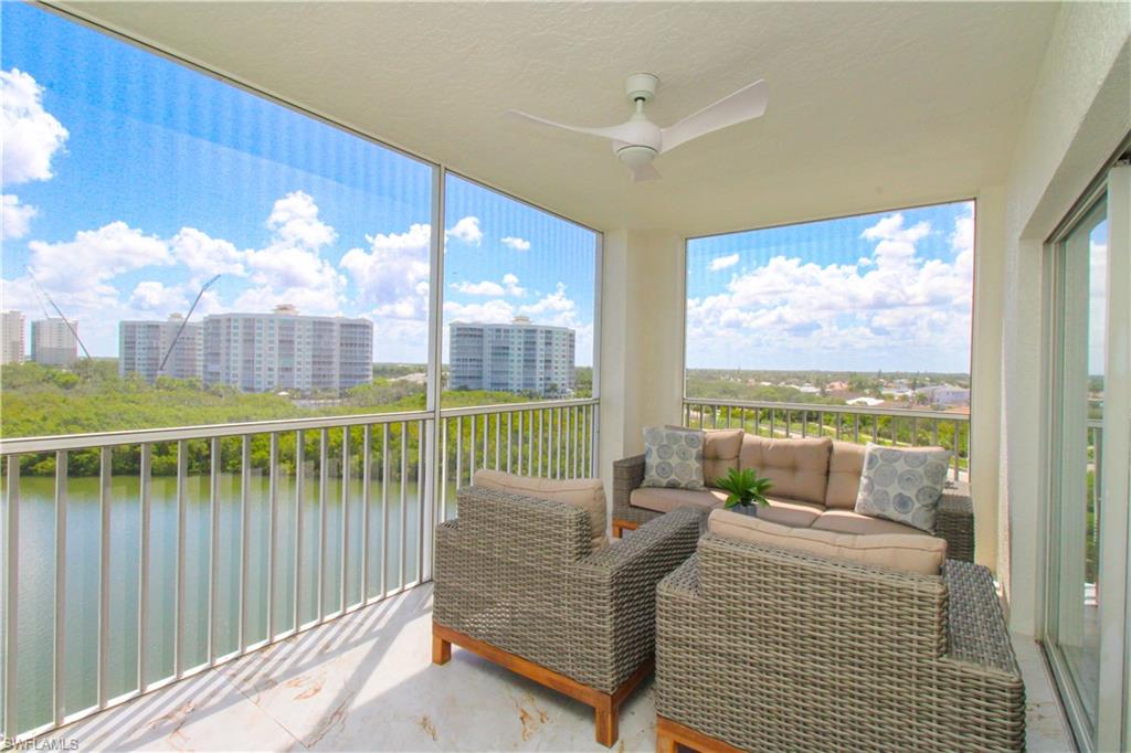Sunroom / solarium featuring a water view and ceiling fan