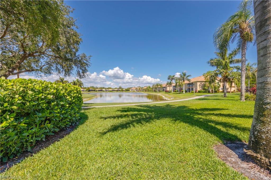 View of grassy yard with a water view