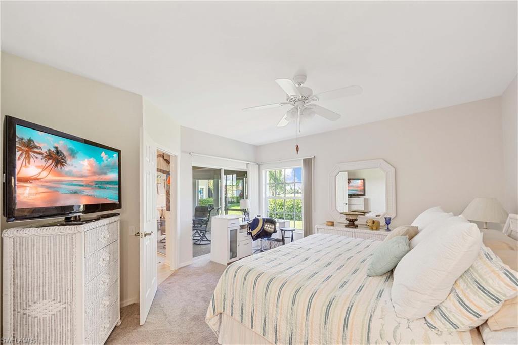 Bedroom featuring light colored carpet, ceiling fan, baseboards, and access to outside