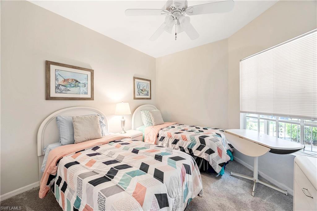 Bedroom featuring carpet flooring, baseboards, and a ceiling fan
