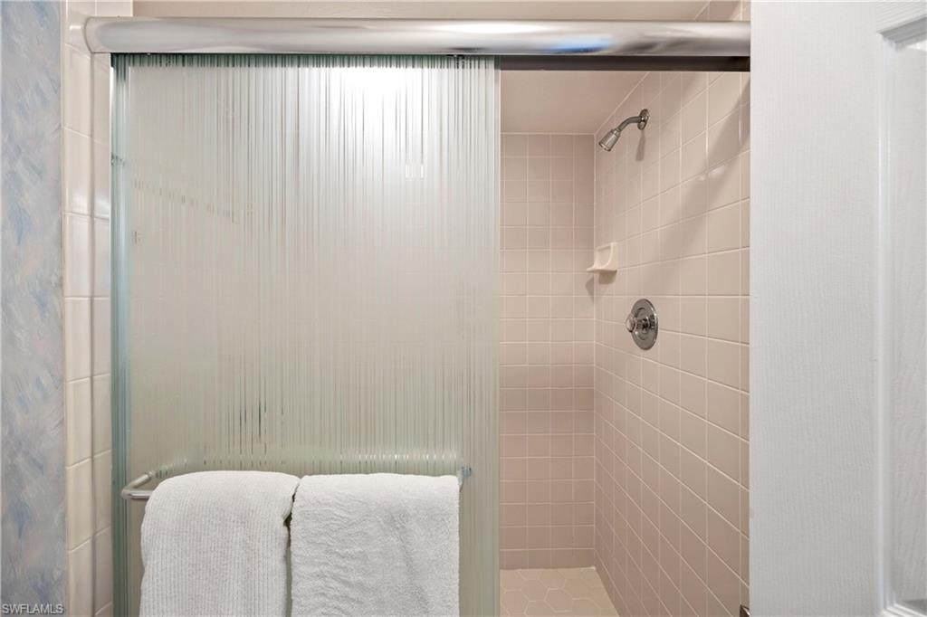 Full bath featuring a shower stall