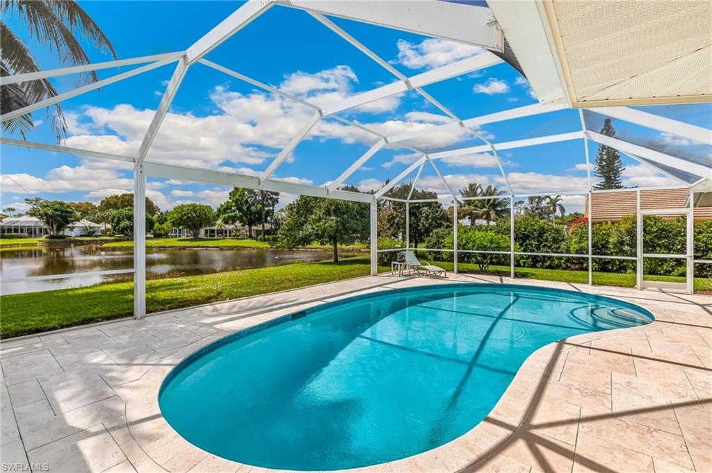 Pool with travertine flooring and panoramic screen