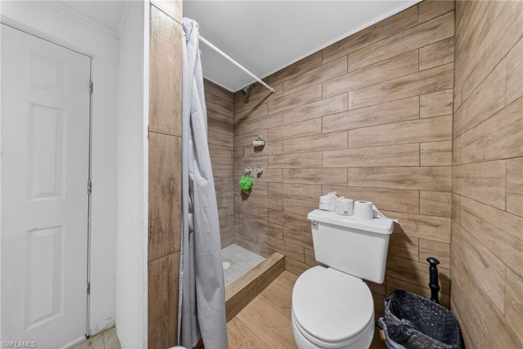 Full bathroom featuring toilet and a stall shower