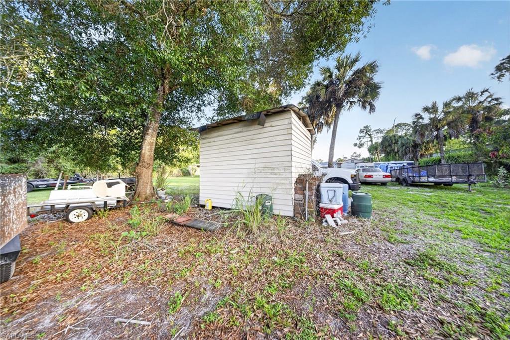 View of grassy yard with an outbuilding