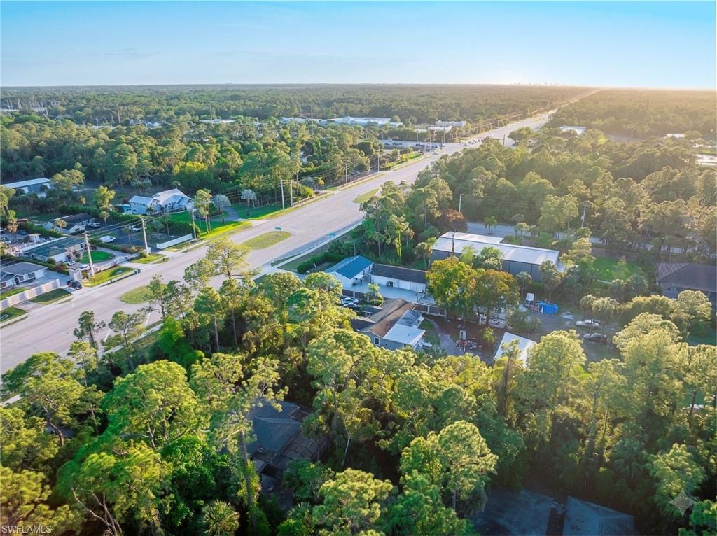 Aerial view of residential area featuring a heavily wooded area