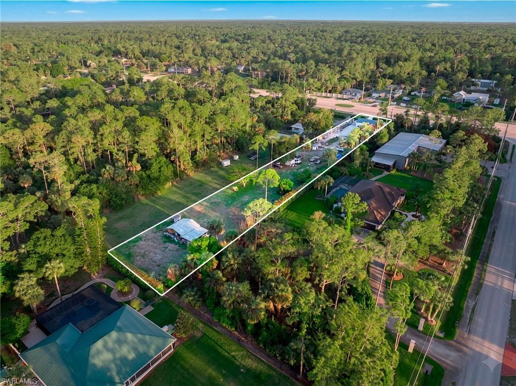 Aerial overview of property's location featuring a heavily wooded area and property boundaries highlighted