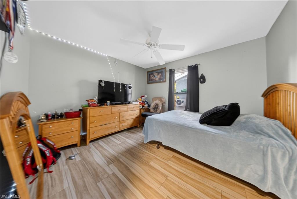 Bedroom with ceiling fan and light wood-style floors