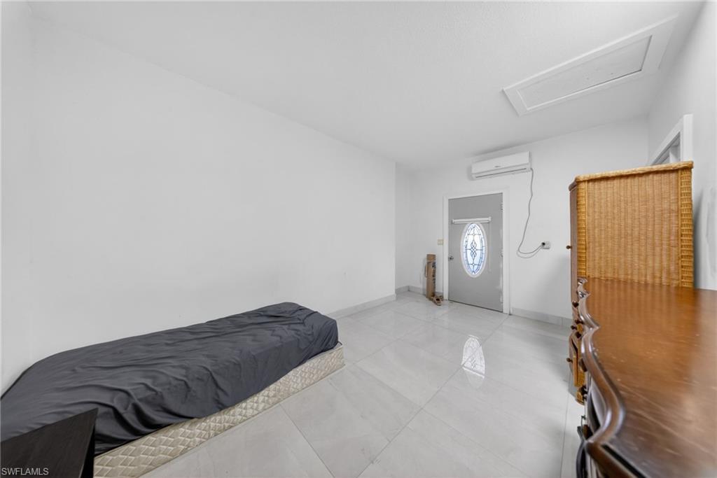 Bedroom with attic access and a mini split for heating / cooling