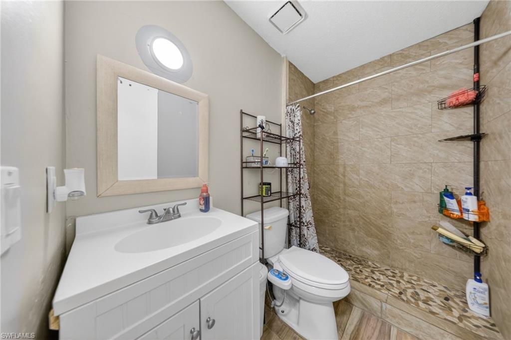 Bathroom featuring vanity and a stall shower