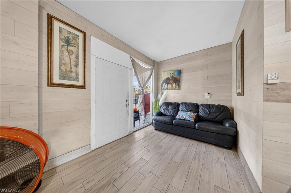 Living area featuring wood walls and wood finish floors