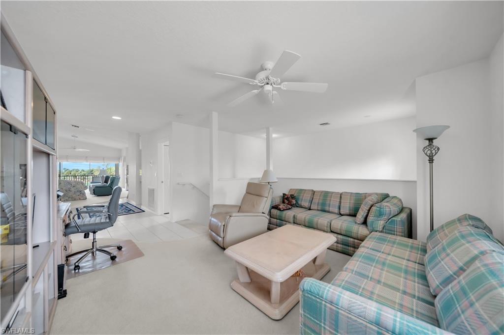 Living room with ceiling fan, recessed lighting, and an office area