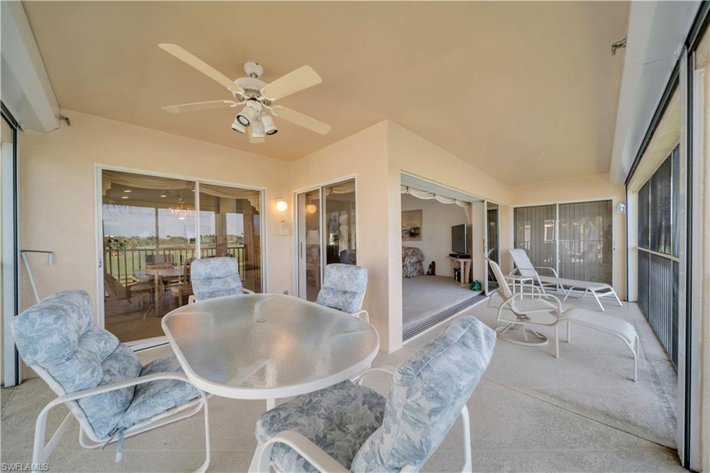 Sunroom with outdoor dining space, a ceiling fan, and a patio area