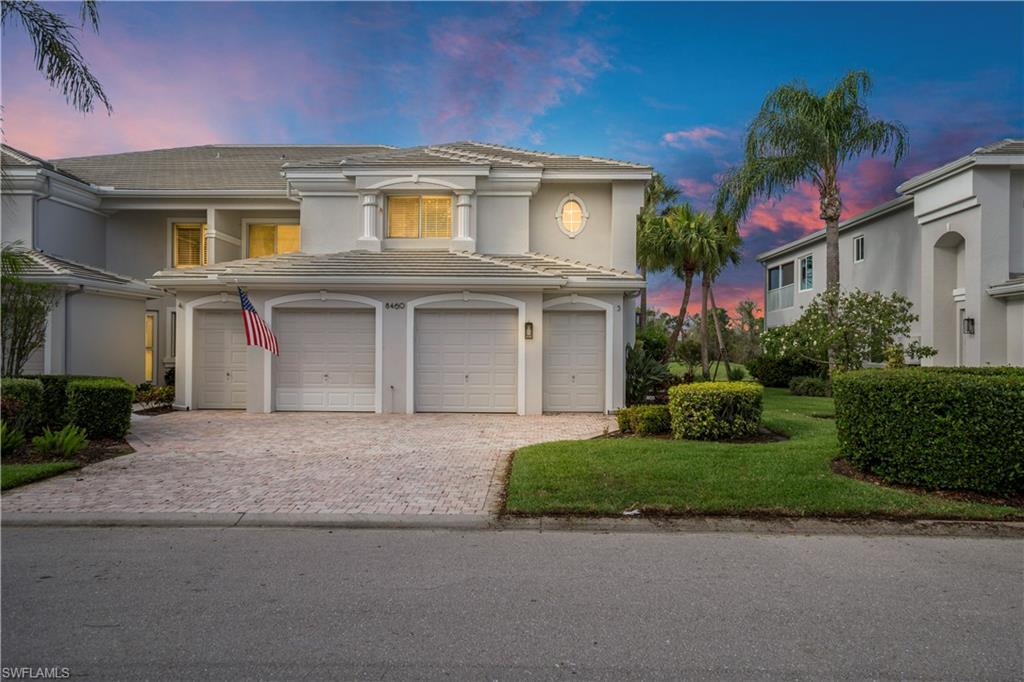 Mediterranean / spanish house featuring decorative driveway, a tiled roof, stucco siding, and a front yard