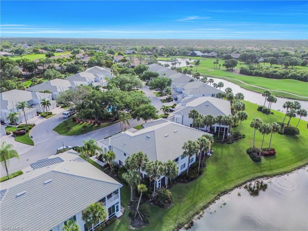Aerial perspective of suburban area with a golf club and a nearby body of water
