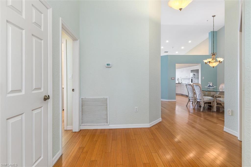Entryway featuring wood floors and a high ceiling.