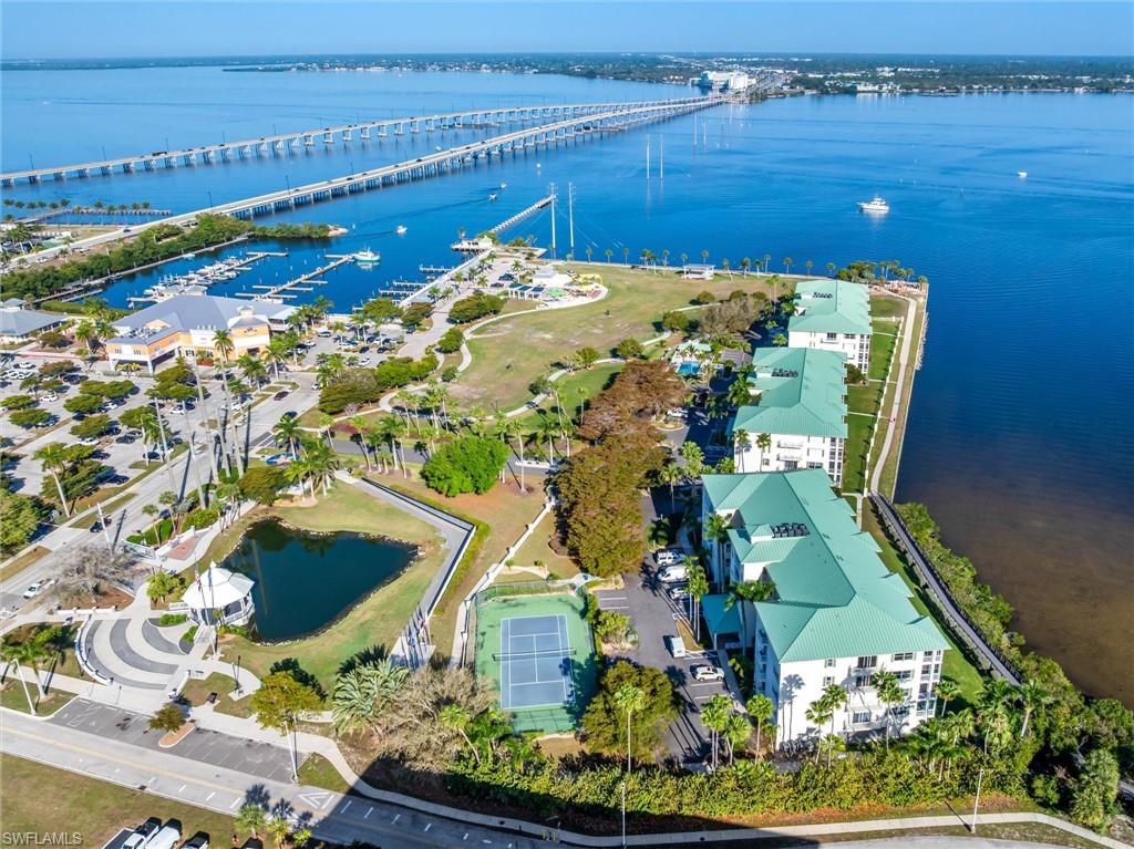 Aerial view of three Harbor Walk condo buildings, Laishley park, marina and north bound US-41 bridge to Port Charlotte
