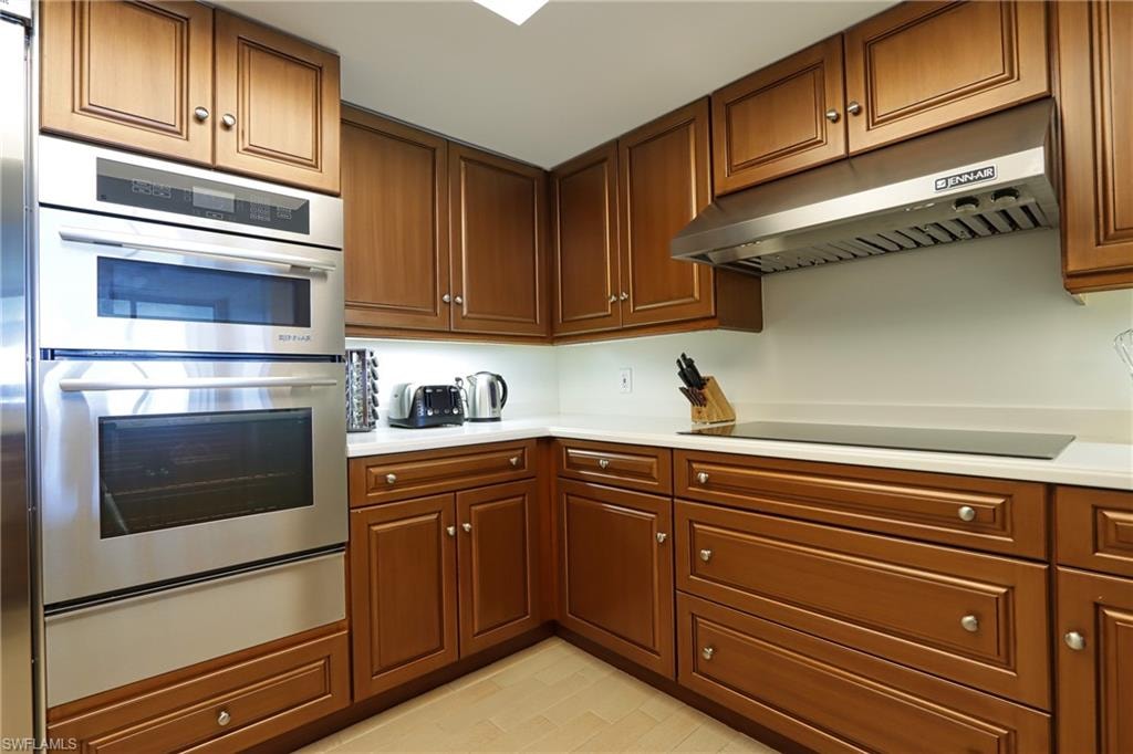 Kitchen featuring black electric stovetop and double oven