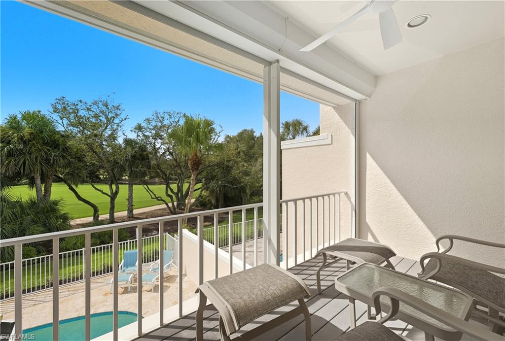 Balcony featuring a ceiling fan, golf course view, and view of pool