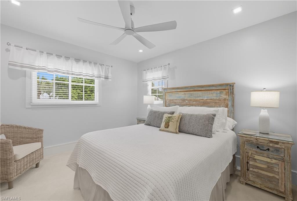 Bedroom with recessed lighting, a ceiling fan, and light carpet