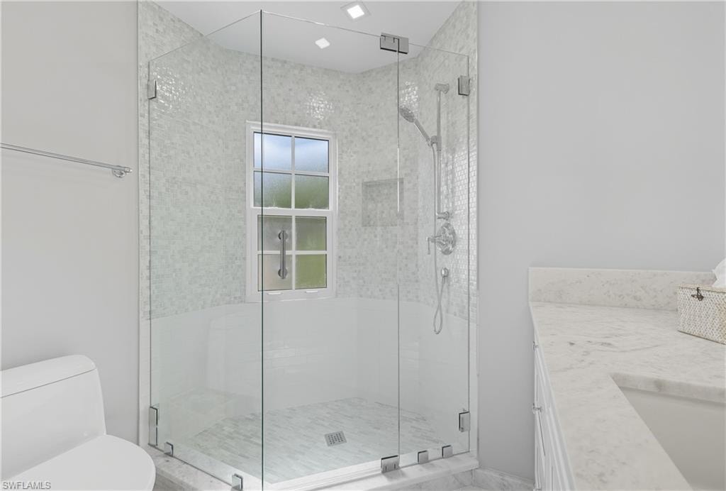 Full bathroom with a stall shower and vanity