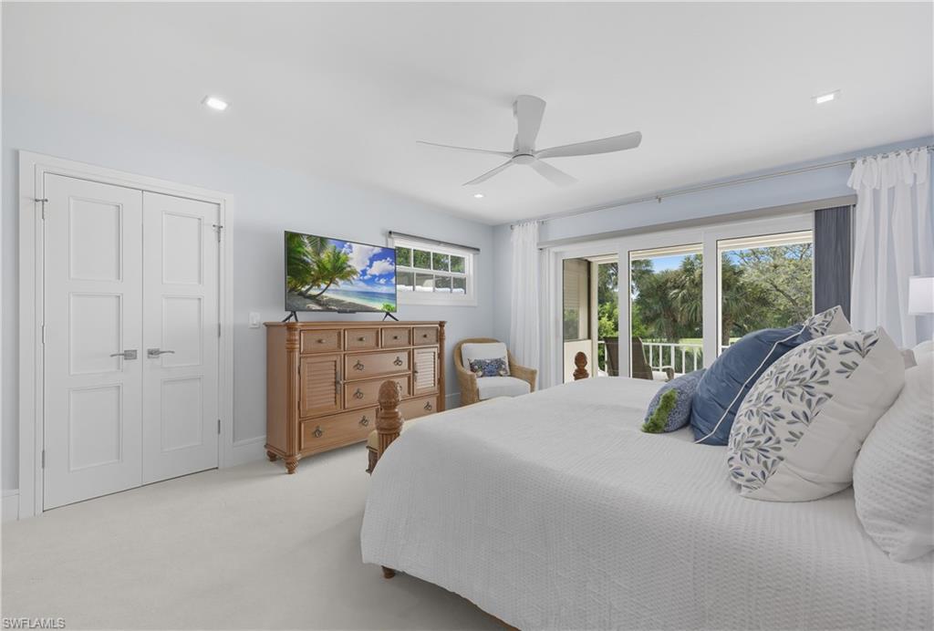 Carpeted bedroom featuring access to exterior, a ceiling fan, and recessed lighting