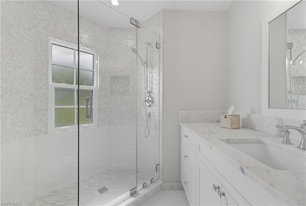 Bathroom with vanity and a shower stall