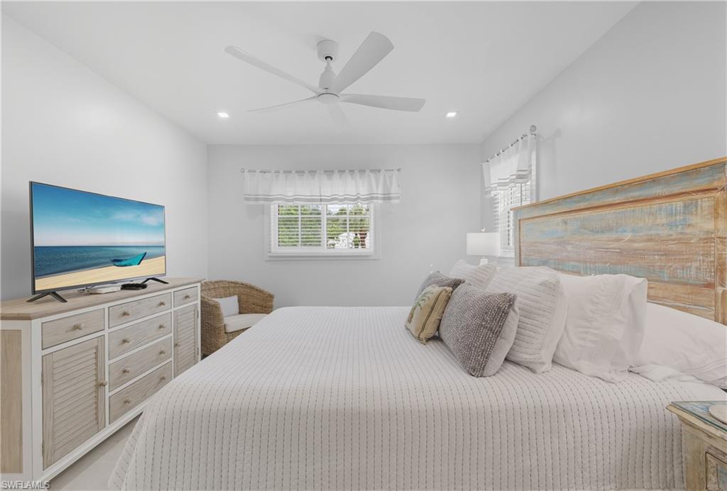 Bedroom with a ceiling fan and recessed lighting