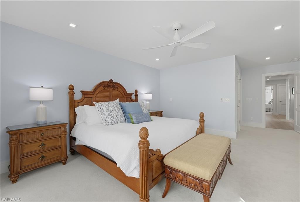 Bedroom with light colored carpet, a ceiling fan, and recessed lighting
