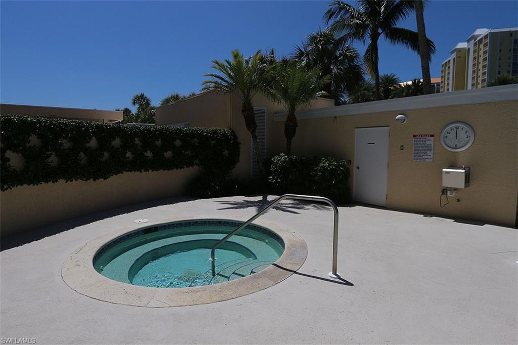 View of pool with a hot tub