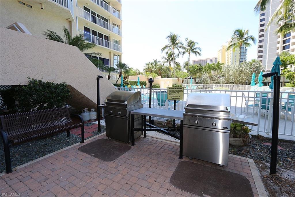 View of terrace with a balcony and area for grilling