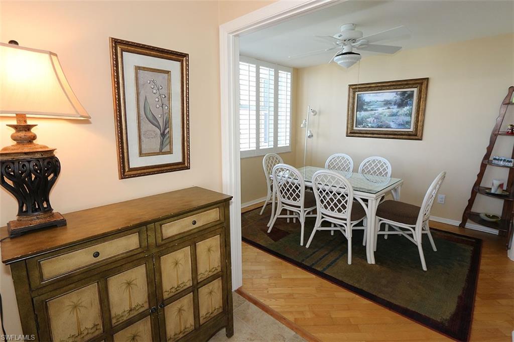 Dining area with ceiling fan and hardwood / wood-style flooring