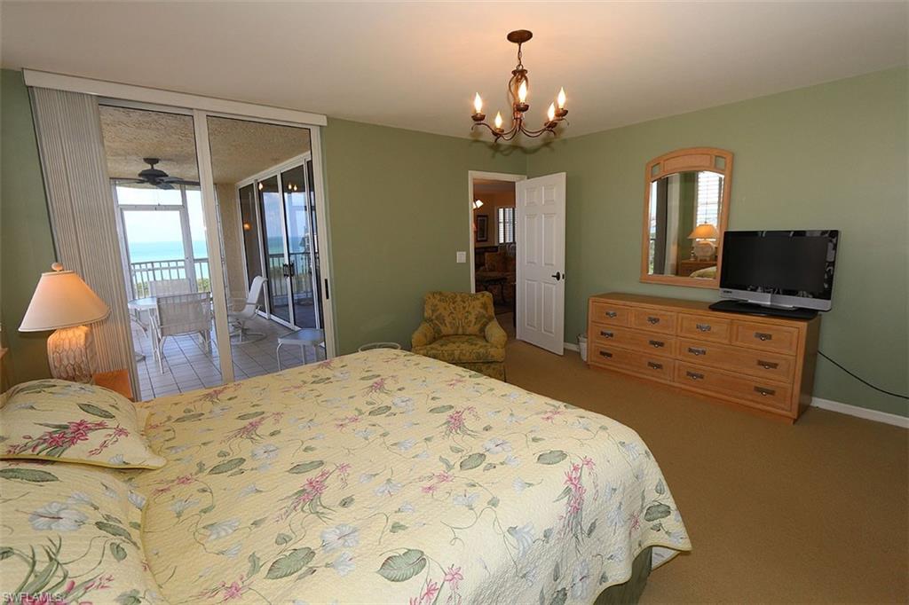 Bedroom with access to outside, a chandelier, and carpet floors