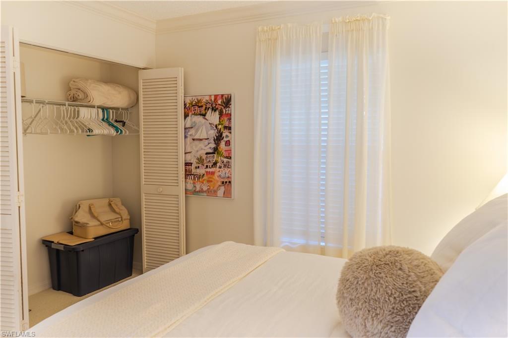 Bedroom featuring a closet and crown molding
