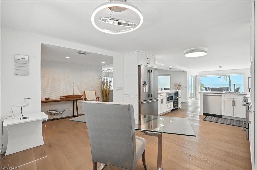 Dining area featuring light wood-style floors and wine cooler