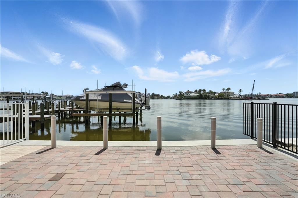 Dock area featuring boat lift and a water view