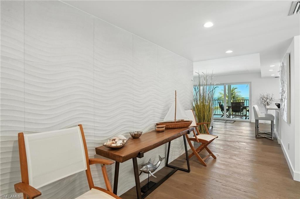 Hall featuring wood finished floors and recessed lighting