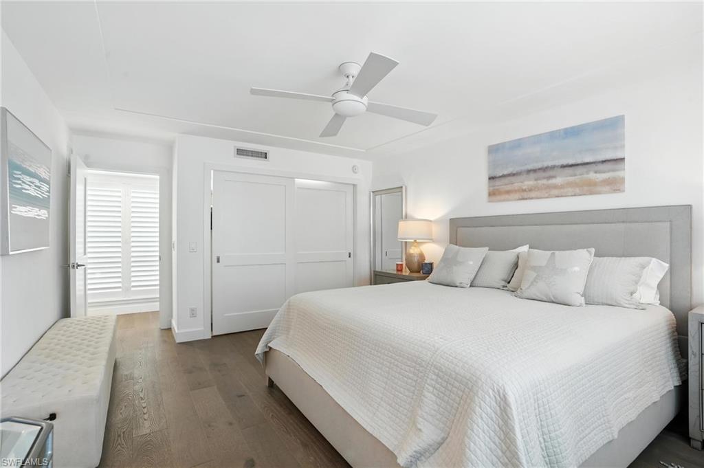 Bedroom featuring wood finished floors, a closet, and a ceiling fan