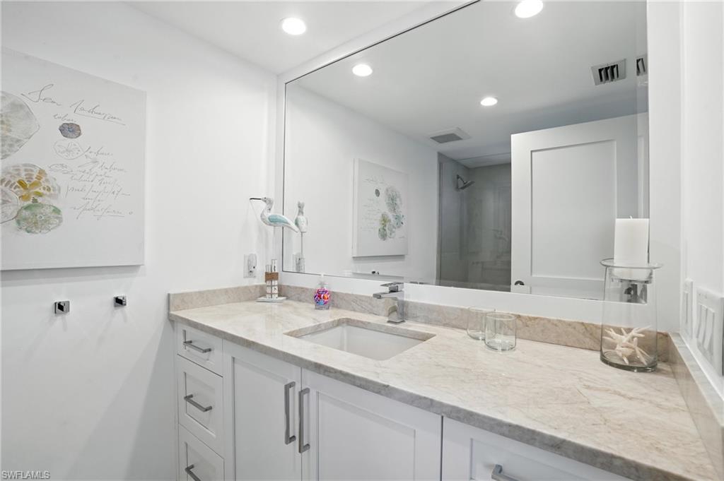 Full bathroom with recessed lighting and vanity