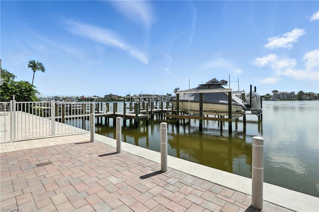 Dock featuring boat lift and a water view