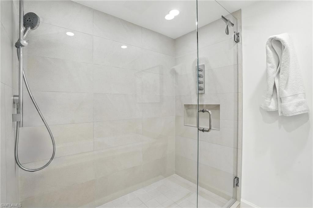 Bathroom featuring a shower stall and recessed lighting