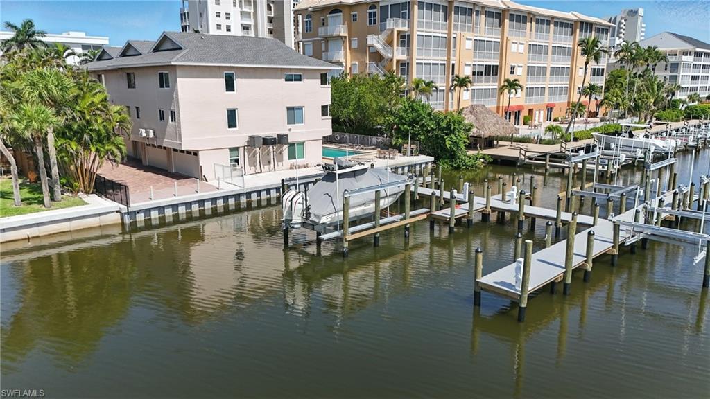 Dock area featuring boat lift and a water view