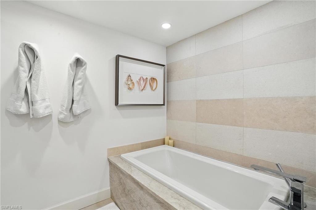 Bathroom featuring a bath and recessed lighting