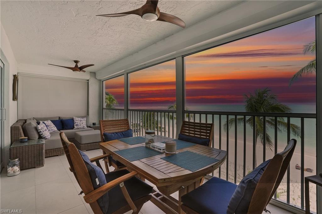 Sunroom with a water view, tile patterned floors, and a textured ceiling