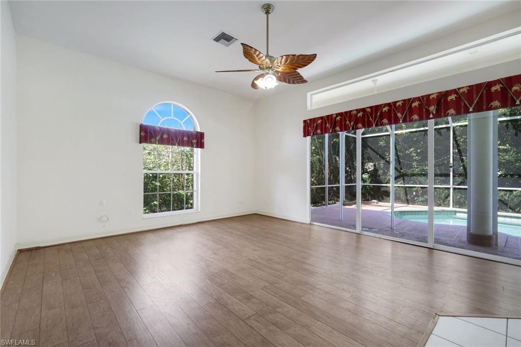 Living room features lanai access and gorgeous pool views.