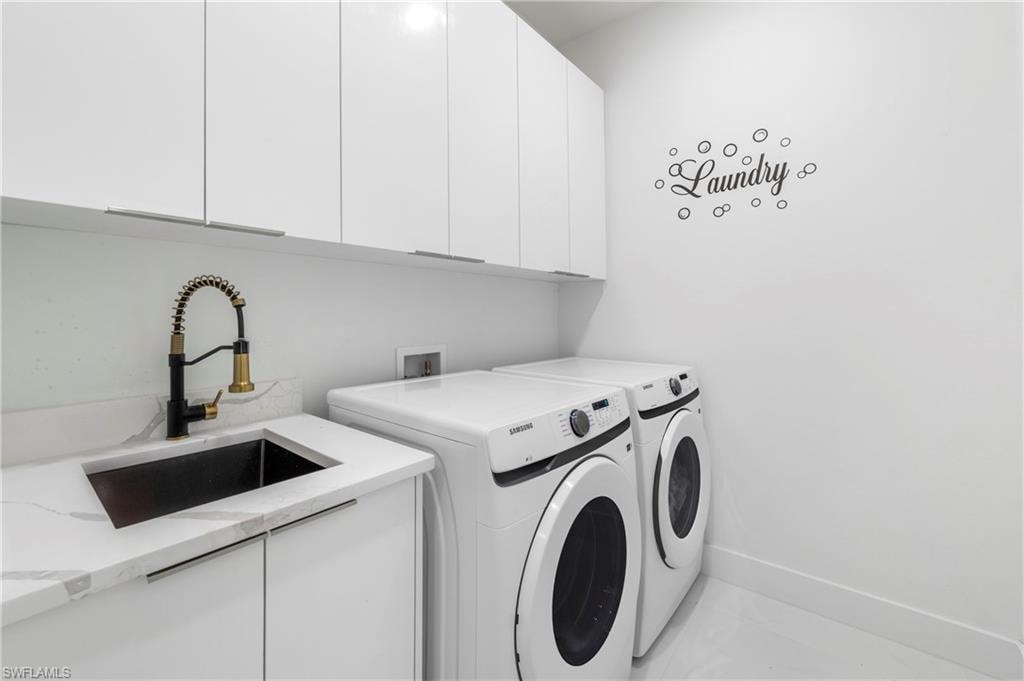 Utility room featuring white cabinetry, a black sink with a coil spring faucet, a light-toned countertop, and light-toned flooring